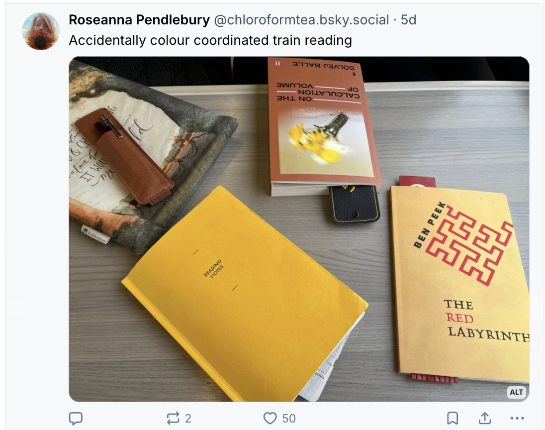 Train table with yellow and brown books on including The Red Labyrinth (yellow with red maze)