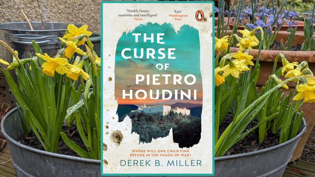 Book Cover of The Curse of Pietro Houdini overlaying some miniature daffodils